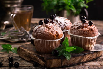 Blueberry muffins with powdered sugar and fresh berries