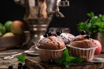 Blueberry muffins with powdered sugar and fresh berries