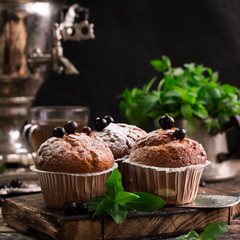 Blueberry muffins with powdered sugar and fresh berries