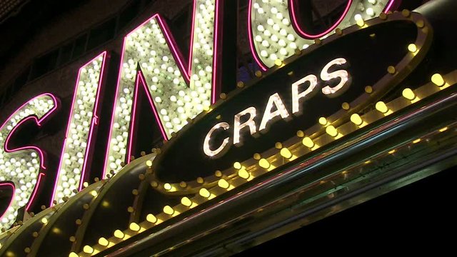 A perspective view looking up at a craps sign at a Las Vegas casino.