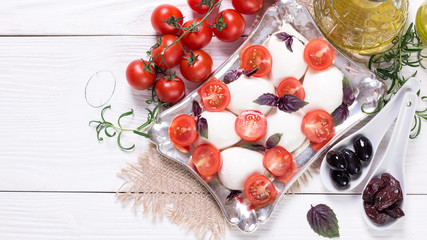 Fototapeta na wymiar mozzarella, cherry tomatoes and fresh basil - ingredients for caprese salad