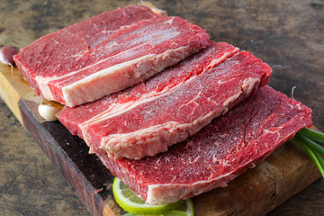 Fototapeta premium Slide top round beef preparation for cooking