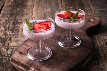 Healthy breakfast or morning snack with chia seeds strawberries yogourt vegetarian food, diet and health concept