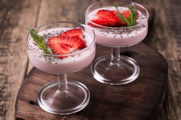 Healthy breakfast or morning snack with chia seeds strawberries yogourt vegetarian food, diet and health concept