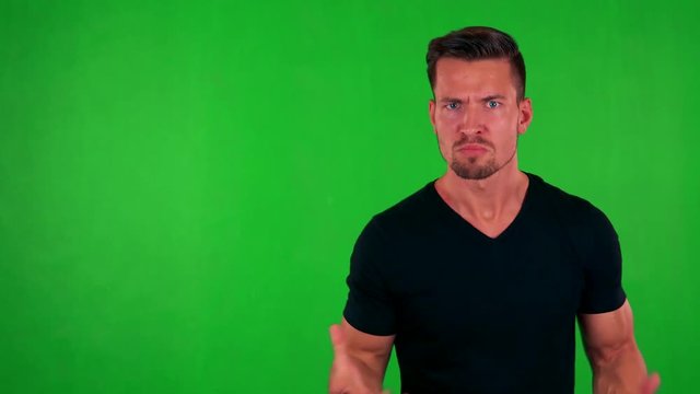 young handsome caucasian man is angry to camera - green screen - studio