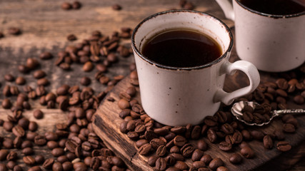 coffee cup with roasted  beans on wooden background