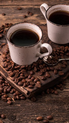 coffee cup with roasted  beans on wooden background