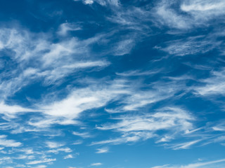 Whispy white clouds in a natural blue sky