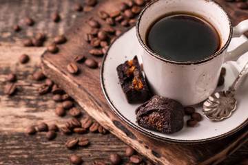 coffee cup with roasted  beans on wooden background