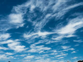 Whispy white clouds in a natural blue sky