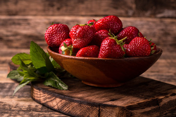 Ripe red strawberries on vintage wooden table