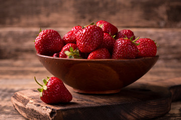 Ripe red strawberries on vintage wooden table
