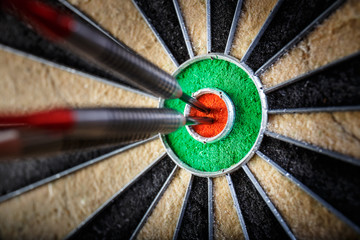 three darts in bull's eye, close up