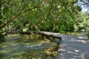 Naklejka premium A wooden walkway on the River Krka in Krka National Park, Sibenik-Knin County, Croatia. It is part of the part of the 1900m Skradinski Buk Waterfall trail