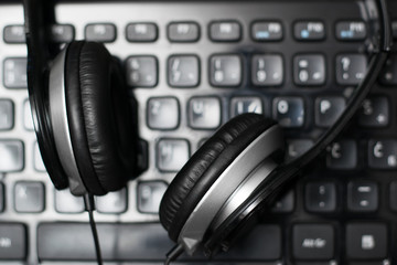 Obraz na płótnie Canvas Headphones on laptop keyboard