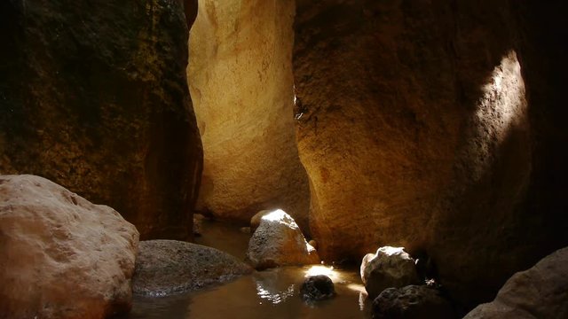  torrent of water, bathed in the golden light on its walls 