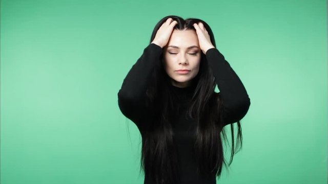Young brunette woman demonstrating long  healthy hair, green screen background