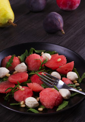 Watermelon, Mozzarella cheese and Arugula Salad with Pine Nuts. Healthy Vegetarian and Detox Salad.  View from above, top studio shot