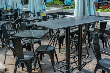 Wooden tables and chairs at the outside of restaurant.
