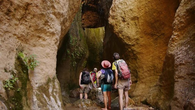   group of people hiking in the golden river in the valley of Lecrin, Granada 