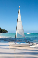 Sailing boat - a catamaran on the beach