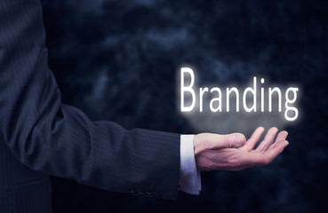 Businessman holding a Branding Concept