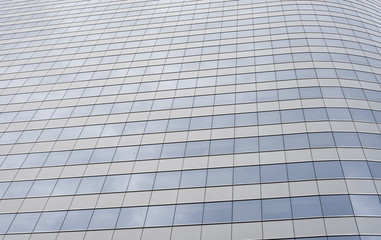 glass modern business office building with cloud and sky reflecting,selective focus