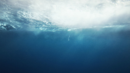 Beautiful underwater sea scene view with natural light rays, slow motion, the water glittering and...