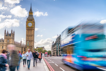 Fast moving tourists and traffic along Westminster Bridge, Londo