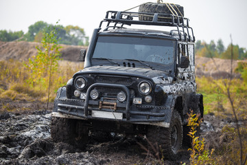 Fototapeta na wymiar Russian off road car UAZ in mud