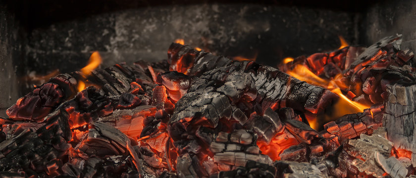 Hot coals and some fire in the oven. You just fell the heat coming of this image. Burning coals in crisp detail, with a slight panoramic style. 