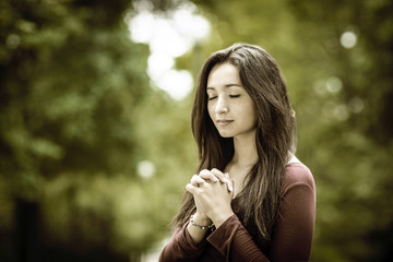 Woman praying outdoors