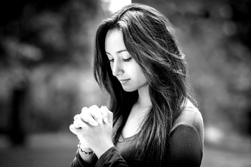 Woman praying outdoors