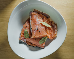 red fish with spices on the white plate