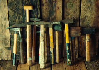 Many old hammers in carpenter's workshop