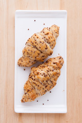 Two croissant on white dish