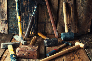 Many old hammers in carpenter's workshop