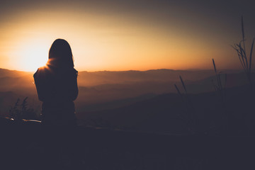 Single adult woman silhouette and sunset vintage style