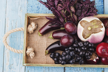Set of raw vegetables in the tray, wooden background