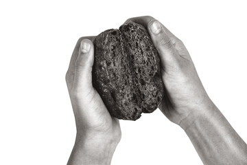 Naklejka premium Bread is torn in half in children hands isolated