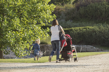 Mom with stroller and daughter for a walk