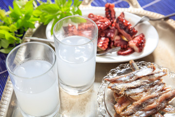 Two glasses of ouzo and appetizers