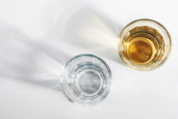 Shot glass of Brazilian cachaca isolated on white background