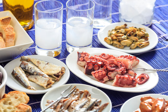 Two glasses of ouzo and appetizers