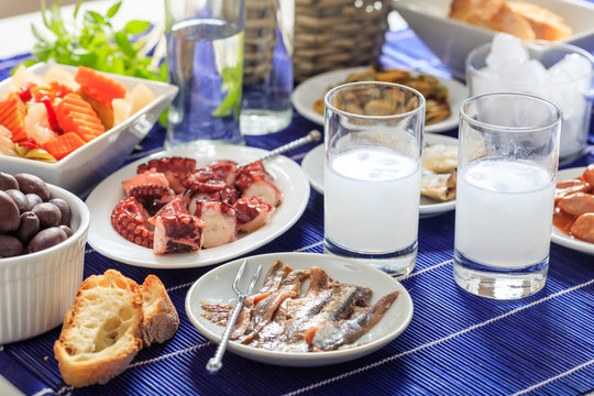 Two glasses of ouzo and appetizers