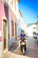 Fancy man riding a scooter in the south