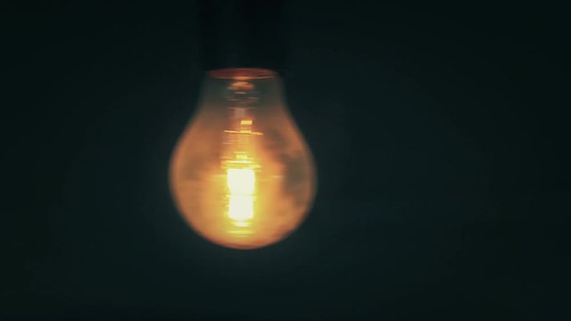 A flickering incandescent light bulb