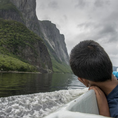 Boy enjoying Western Brook Pond fjord boat tour, Gros Morne Nati