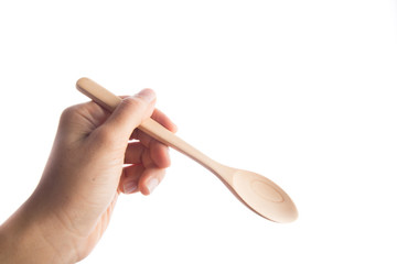 Woman hand taking wooden spoon