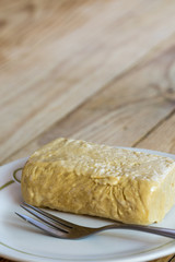 Sweet halva on the plate on the wooden old retro table